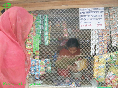 Phoolmati selling wares to a woman in her shop